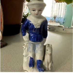 Holland Delft Blue style, a boy walking with his dog and carrying a package or b